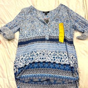 Blue and white floral print top with v neck and 3/4 button.  Cuffed sleeves